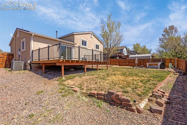 3781 Red Cedar Dr, Colorado Springs, CO 80906 - back of property featuring a deck, cooling unit, a fenced backyard, stucco siding, and a lawn