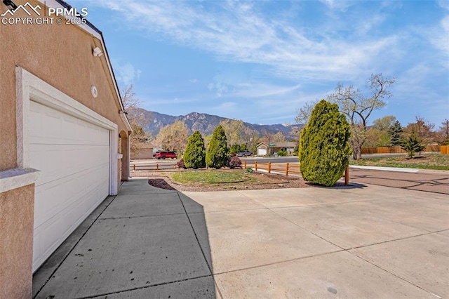 3781 Red Cedar Dr, Colorado Springs, CO 80906 - exterior space with a garage, fence, and a mountain view