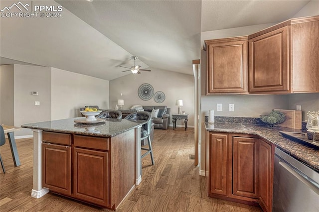 9812 Fairway Glen Dr, Peyton, CO 80831 - kitchen featuring stainless steel dishwasher, vaulted ceiling, wood finished floors, and ceiling fan