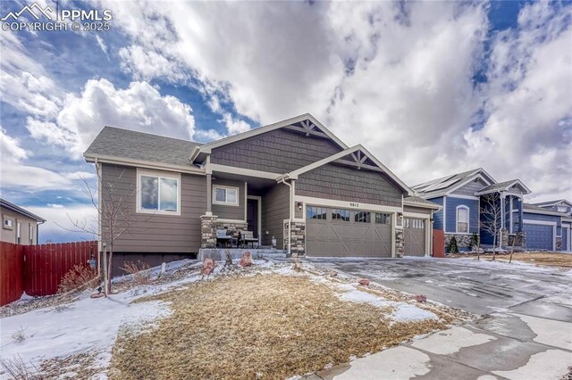9812 Fairway Glen Dr, Peyton, CO 80831 - view of front facade featuring stone siding, a garage, concrete driveway, and fence