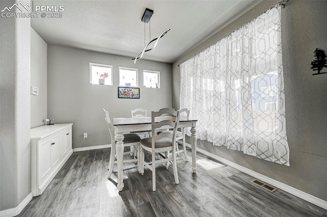 10790 Rolling Peaks Dr, Peyton, CO 80831 - dining area with baseboards, dark wood-style floors, and visible vents
