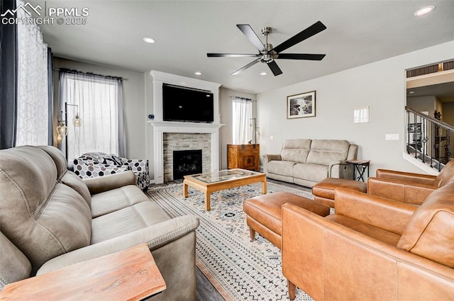 10790 Rolling Peaks Dr, Peyton, CO 80831 - living area with a stone fireplace, stairs, recessed lighting, and a ceiling fan