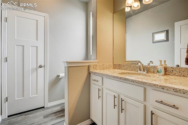 10790 Rolling Peaks Dr, Peyton, CO 80831 - bathroom with vanity, baseboards, and wood finished floors