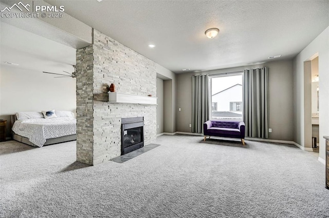 10790 Rolling Peaks Dr, Peyton, CO 80831 - carpeted living area with baseboards, a fireplace, a ceiling fan, and a textured ceiling