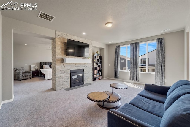 10790 Rolling Peaks Dr, Peyton, CO 80831 - living area with carpet, baseboards, a textured ceiling, visible vents, and a stone fireplace