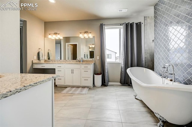 10790 Rolling Peaks Dr, Peyton, CO 80831 - bathroom featuring visible vents, tile patterned floors, recessed lighting, vanity, and a freestanding bath
