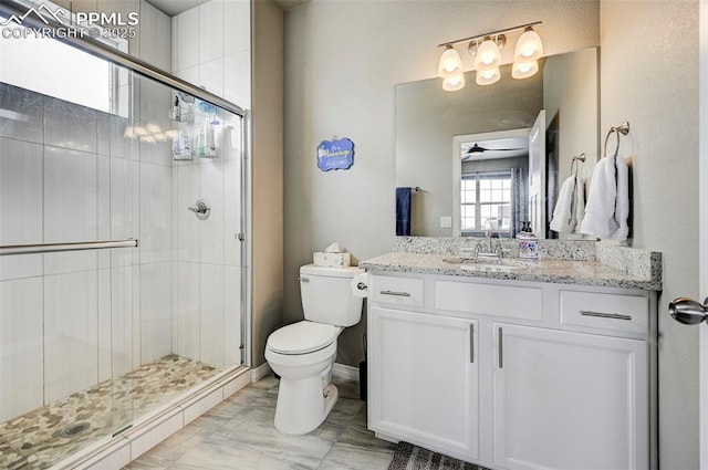 10790 Rolling Peaks Dr, Peyton, CO 80831 - full bathroom featuring toilet, vanity, a stall shower, and ceiling fan