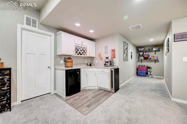 10790 Rolling Peaks Dr, Peyton, CO 80831 - kitchen with white cabinets, beverage cooler, fridge, and visible vents