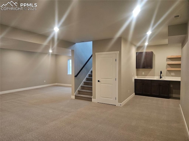 16207 Talons Bluff Ln, Monument, CO 80132 - basement featuring light colored carpet, stairway, and recessed lighting