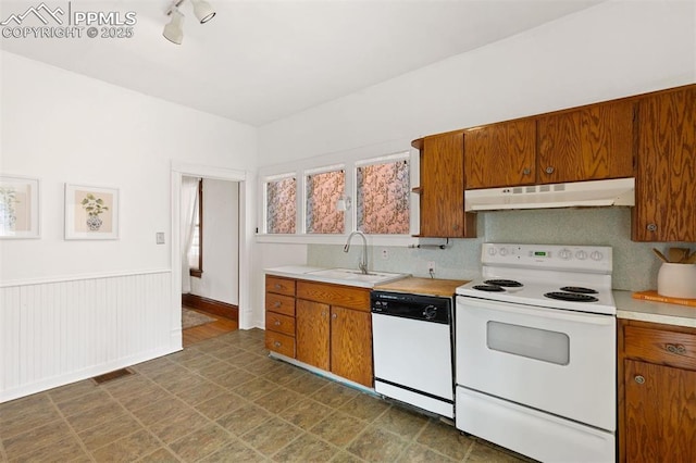 2721 W Bijou St, Colorado Springs, CO 80904 - kitchen with white appliances, a sink, under cabinet range hood, light countertops, and brown cabinetry