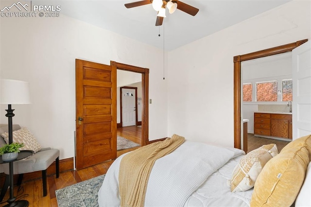 2721 W Bijou St, Colorado Springs, CO 80904 - bedroom featuring wood finished floors, a sink, baseboards, and a ceiling fan