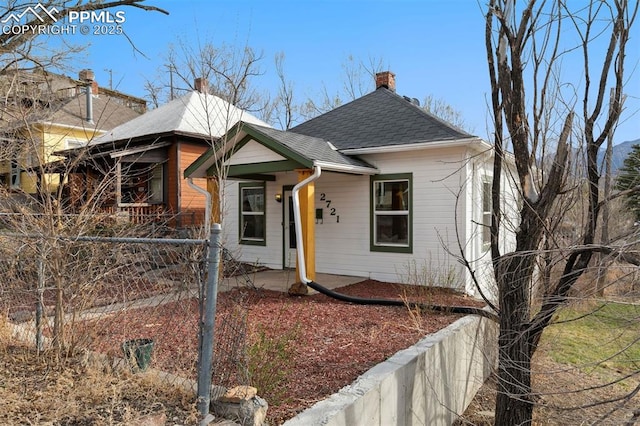 2721 W Bijou St, Colorado Springs, CO 80904 - view of front facade with a chimney and roof with shingles