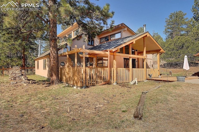 5581 County Road 328, Westcliffe, CO 81252 - rear view of house with stucco siding and a lawn