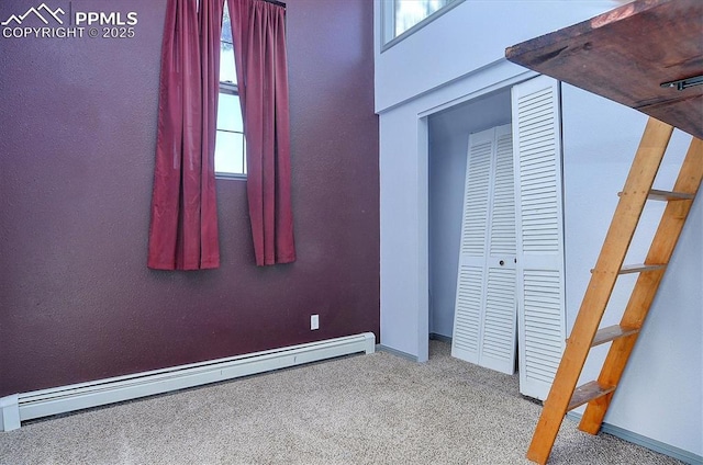 5581 County Road 328, Westcliffe, CO 81252 - unfurnished bedroom with a closet, carpet floors, baseboards, and a baseboard radiator
