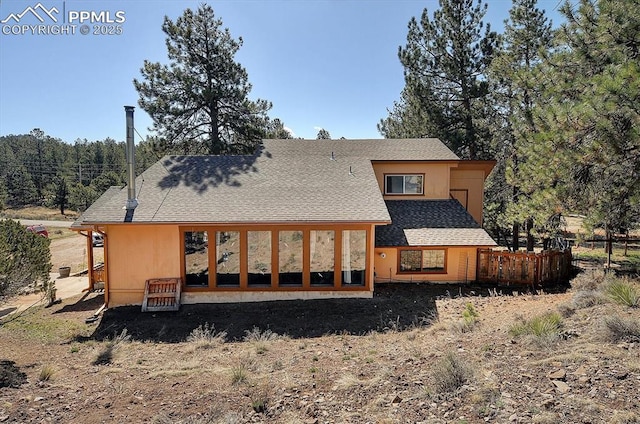 5581 County Road 328, Westcliffe, CO 81252 - rear view of house with stucco siding, fence, and a shingled roof