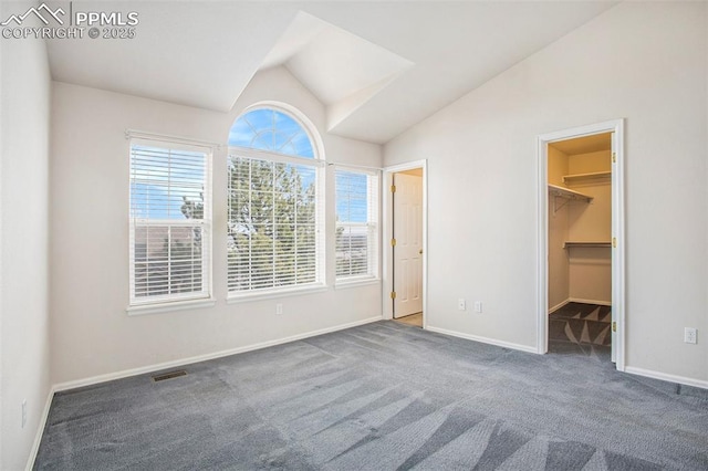 3272 Capstan Way, Colorado Springs, CO 80906 - unfurnished bedroom featuring vaulted ceiling, carpet flooring, a walk in closet, baseboards, and visible vents
