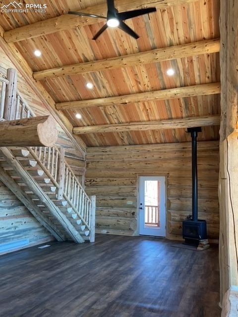 1906 Korlkoff Ln, Fort Garland, CO 81133 - unfurnished living room featuring ceiling fan, beamed ceiling, wooden ceiling, a wood stove, and wood finished floors