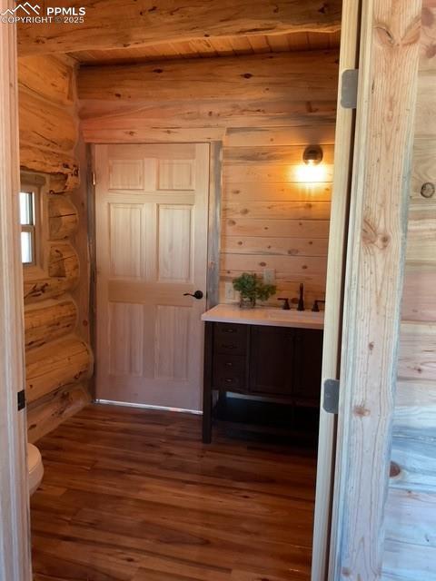 1906 Korlkoff Ln, Fort Garland, CO 81133 - bathroom featuring rustic walls, wooden ceiling, toilet, and wood finished floors