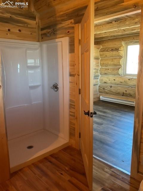 1906 Korlkoff Ln, Fort Garland, CO 81133 - full bathroom with wood finished floors, a stall shower, and rustic walls