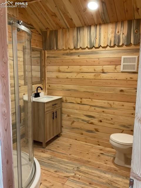 1906 Korlkoff Ln, Fort Garland, CO 81133 - bathroom with wood walls, wood ceiling, toilet, a stall shower, and vanity