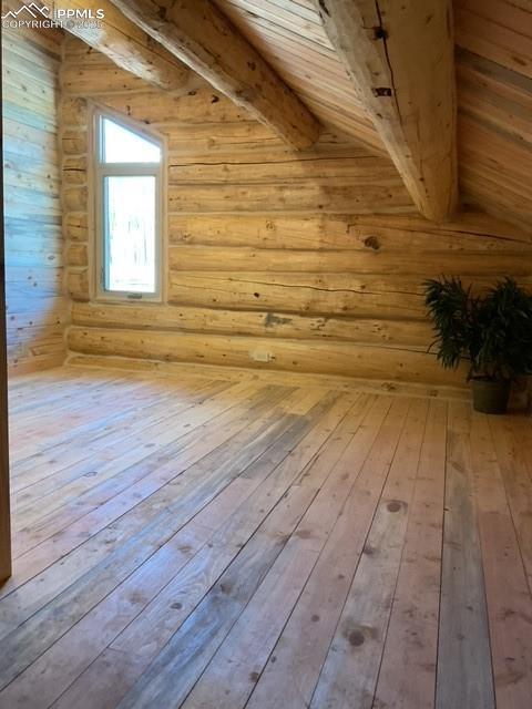 1906 Korlkoff Ln, Fort Garland, CO 81133 - additional living space with beamed ceiling, log walls, and hardwood / wood-style floors