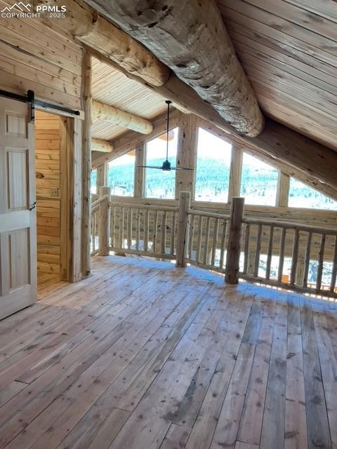 1906 Korlkoff Ln, Fort Garland, CO 81133 - bonus room featuring wood ceiling, vaulted ceiling with beams, a barn door, and hardwood / wood-style floors