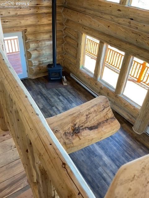 1906 Korlkoff Ln, Fort Garland, CO 81133 - interior details with a baseboard heating unit, wood finished floors, and a wood stove