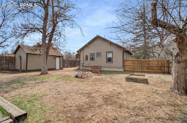 3010 W Kiowa St, Colorado Springs, CO 80904 - rear view of house featuring a fenced backyard, an outbuilding, and a garage