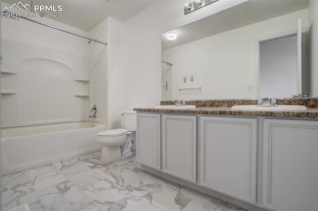 full bathroom featuring marble finish floor, double vanity, toilet, and a sink