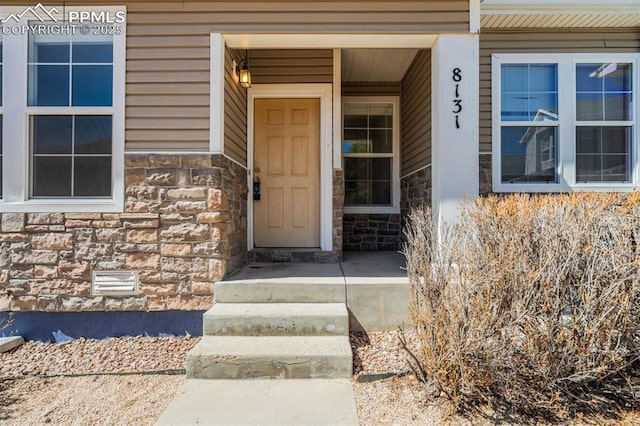 view of exterior entry with stone siding