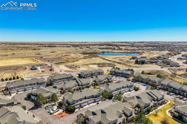 drone / aerial view with a residential view and a water view