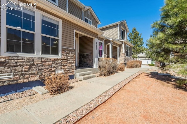 view of exterior entry featuring stone siding
