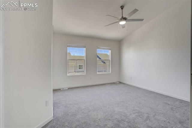 unfurnished room featuring baseboards, lofted ceiling, carpet, and a ceiling fan