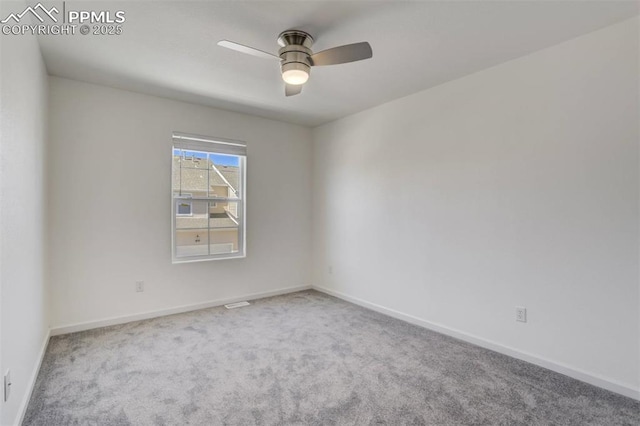 carpeted empty room featuring baseboards and ceiling fan