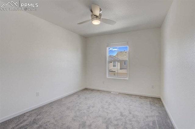 carpeted spare room with baseboards and ceiling fan
