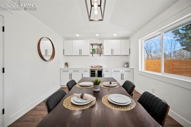 dining space with vaulted ceiling, dark wood-style floors, beverage cooler, baseboards, and recessed lighting
