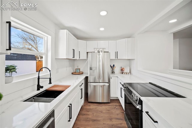 kitchen with dark wood-style floors, white cabinets, a sink, and stainless steel appliances