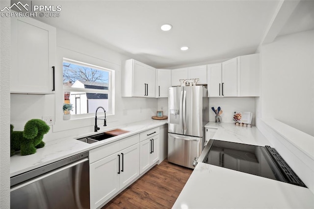 kitchen featuring white cabinetry, a sink, appliances with stainless steel finishes, and recessed lighting