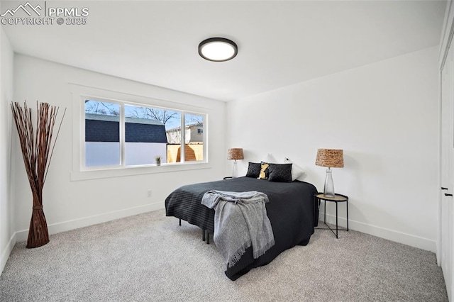 carpeted bedroom featuring baseboards