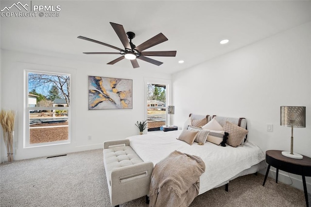 carpeted bedroom featuring a ceiling fan, visible vents, baseboards, and recessed lighting