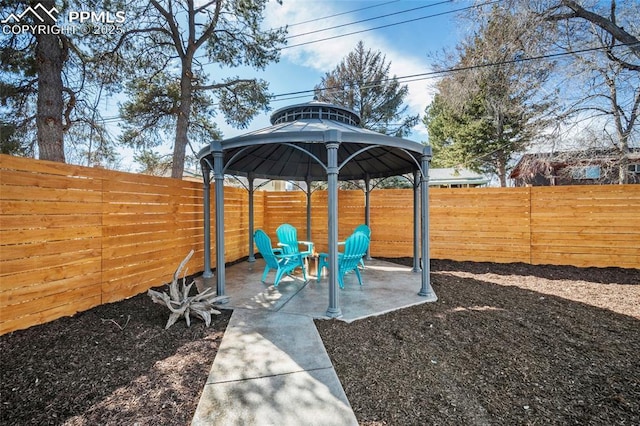 view of yard with a fenced backyard, a gazebo, and a patio area