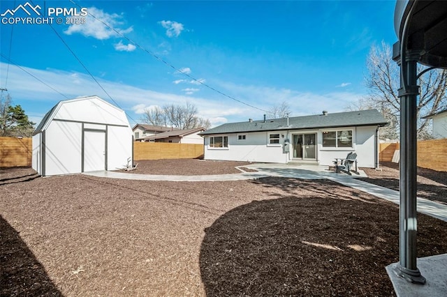 view of yard with a storage unit, an outbuilding, a patio area, and fence private yard