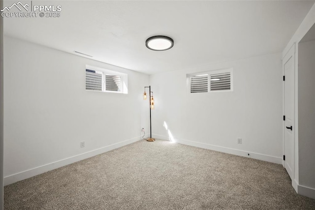 carpeted empty room with baseboards