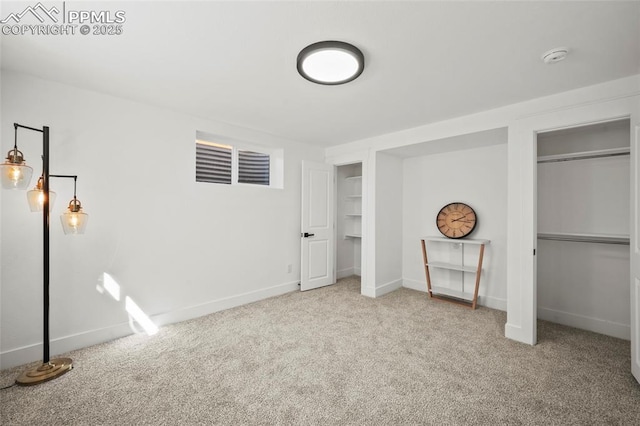 unfurnished bedroom with carpet floors and baseboards