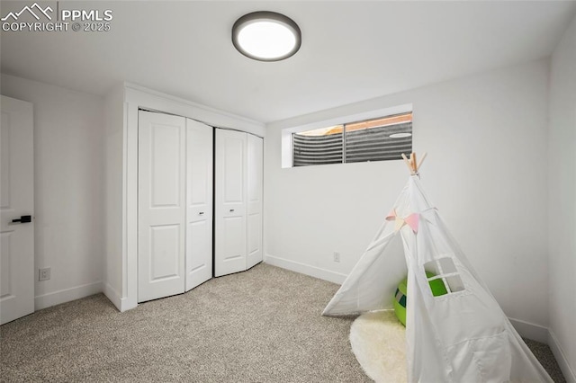 rec room featuring carpet floors and baseboards