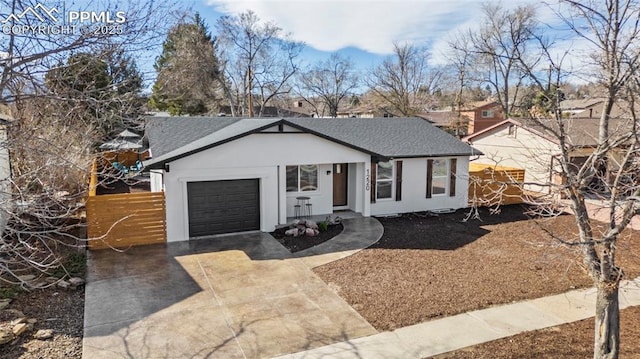 view of front of home with concrete driveway, stucco siding, a garage, and roof with shingles