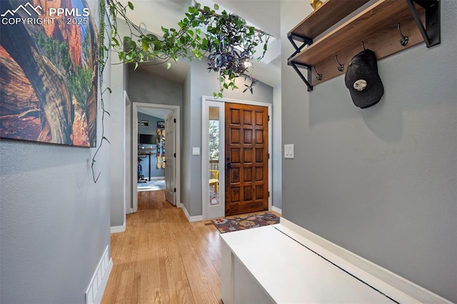entryway with light wood-style floors and baseboards