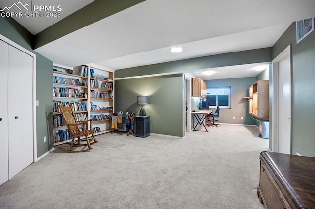 living area featuring carpet and baseboards