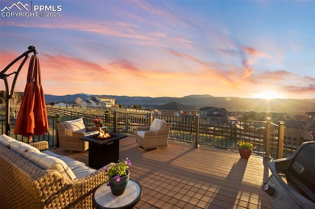 wooden terrace with a mountain view and an outdoor living space with a fire pit