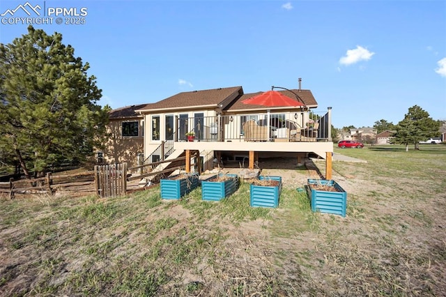 back of house with a wooden deck and stairs